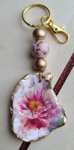 a key chain with a flower painted on it