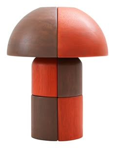 an orange and brown wooden table lamp on a white background in the shape of a mushroom