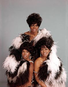 three women dressed in black and white outfits