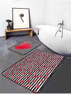 a bath tub sitting next to a bathroom rug