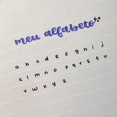 an open notebook with the word new alfabeto written in cursive writing