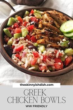 greek chicken bowls with cucumbers, tomatoes, and other vegetables in a bowl