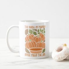 a donut and coffee mug sitting on a table next to each other with the words spice flies the air printed on it