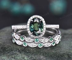 an oval shaped green and white diamond ring