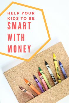 some crayons are sitting in a cork holder with the words help your kids to be smart with money