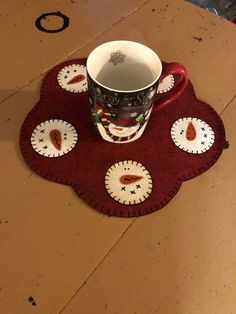 a coffee cup sitting on top of a red rug