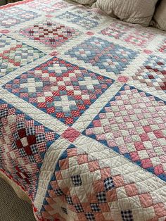 a bed with a quilt on top of it