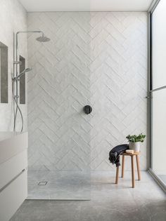 a walk in shower sitting next to a white sink