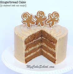 a cake with frosting and gingerbread decorations on it's top slice is cut in half