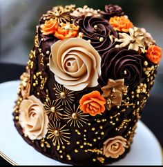 there is a chocolate cake decorated with flowers on the top and gold trimmings