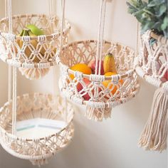 three macrame baskets with fruit in them hanging from the wall