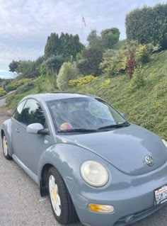 a blue car parked on the side of a road