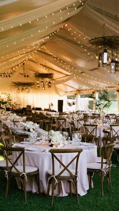 a tent with tables and chairs set up for an event