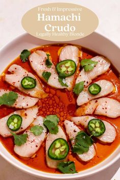 a white bowl filled with food and garnished with green peppers on the side