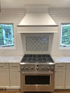 a stove top oven sitting inside of a kitchen