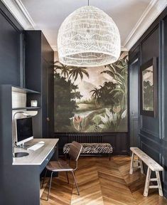 a room with wood floors and a painting on the wall