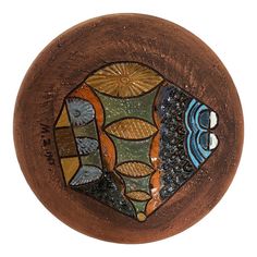 a wooden bowl with an image of fish on it