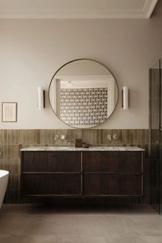 a bathroom with a sink, mirror and bathtub in it's center area