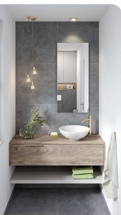 a bathroom with a sink, mirror and towel rack