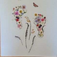 some flowers and a butterfly on a white card