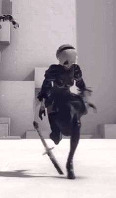 a person in black and white is playing with some skis