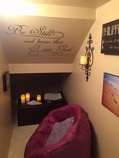 a small room with a bean bag chair and candles on the wall next to it