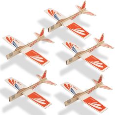 six wooden model airplanes are flying in the air with orange and blue stripes on them