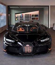 the bugatti supercar is on display at the showroom for people to see