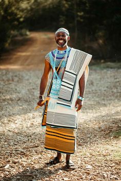 an african man in traditional clothing poses for the camera