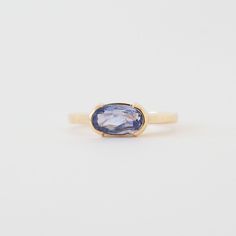 A modern and unexpected departure from the typical engagement ring, the Avery Ring features a stunning East West set blue sapphire. The half-bezel setting makes the stone to really pop, showing off its stunning purple-blue hue. Details 1.58ct Ceylon Blue Sapphire: 9.70x5.40mm 14K yellow gold weighing 4.26 grams Current size: 8 with complementary resize Band width: 2.15mm Half bezel set center stone Low set: looks great with Cleo, Jamie (second photo), and Thea Bands One of a kind center stone Sh Blue Enamel Ring, Bezel Set Sapphire Ring, Bezel Sapphire Ring, East West Sapphire Ring, Blue Moissanite Engagement Ring, Bezel Sapphire Engagement Ring, Unique Gemstone Rings, East West Half Bezel, Sapphire Bezel Ring