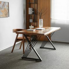 a wooden table sitting in front of a window