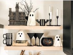 shelves decorated with halloween decorations and candles