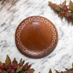 a brown plate sitting on top of a marble counter