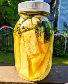 a jar filled with pickles and cucumbers