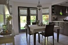 a dining room and kitchen area with tile flooring