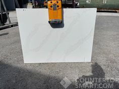 a white marble slab with a yellow machine on top