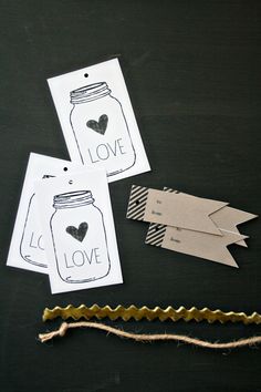 three tags that say love and have hearts in mason jars with twine on them