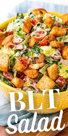 a yellow bowl filled with salad and croutons