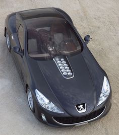 a black sports car parked in the sand