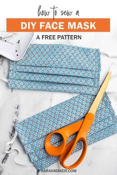 a pair of orange scissors sitting on top of a blue cloth with the words how to sew a diy face mask