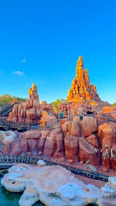 an amusement park with large rocks and water