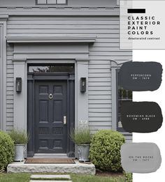 the exterior of a house with gray paint and white trim, including two black doors