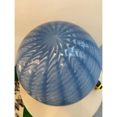 a blue ball sitting on top of a white table