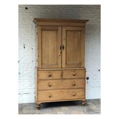 an old wooden dresser with two doors and drawers