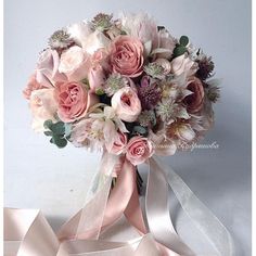 a bridal bouquet with pink and white flowers