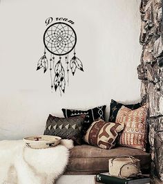 a living room filled with furniture and a dream catcher wall decal on the wall