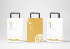 three paper bags with handles on each side