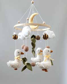 a mobile with stuffed animals hanging from it's sides