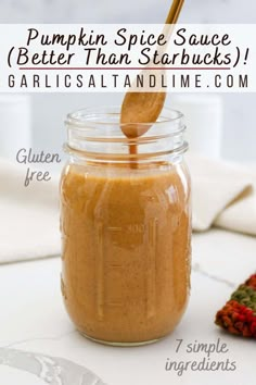 pumpkin spice sauce in a glass jar with a spoon sticking out of it and text overlay that reads, pumpkin spice sauce better than starbucks garlies