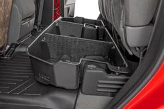 the cargo compartment in the back of a red car